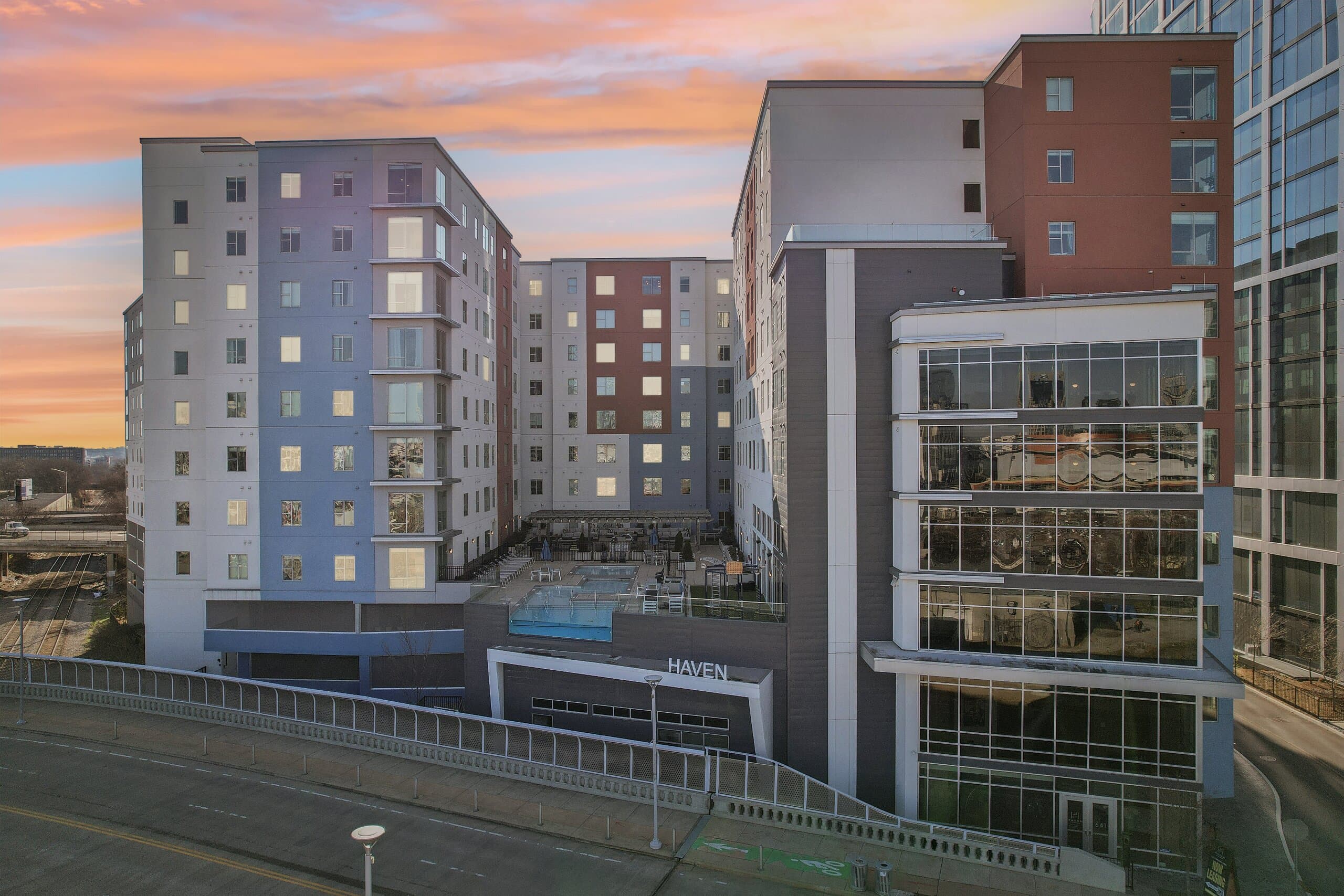 The courtyard pool at Haven at The Gulch glowing at dusk, ringed by the building's residences